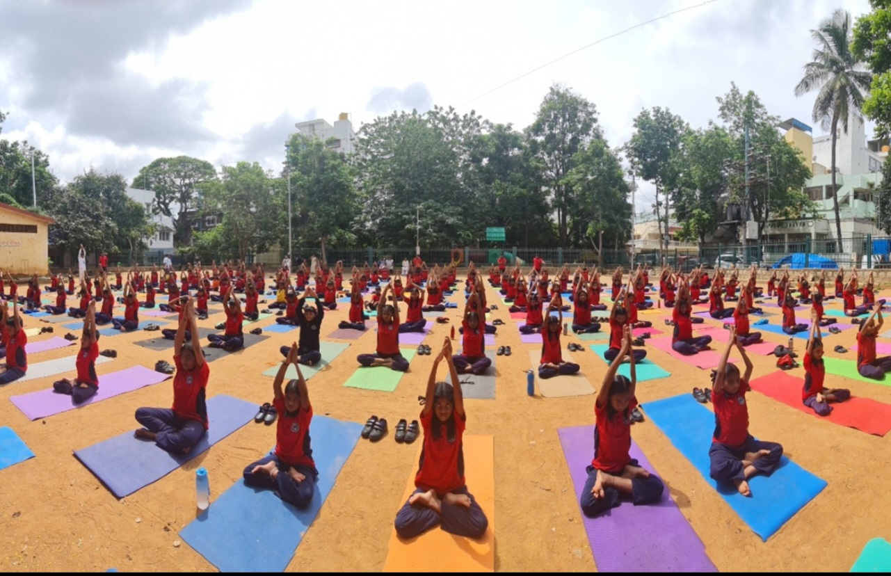 Friendly preschool teacher reading a picture book to attentive young children in a cozy corner